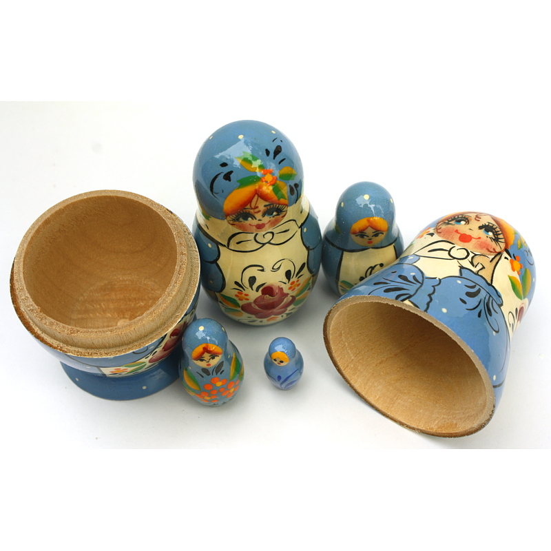 A 5 Nested set of Artists Matryoshka, Blue pink flower on white apron and white dots